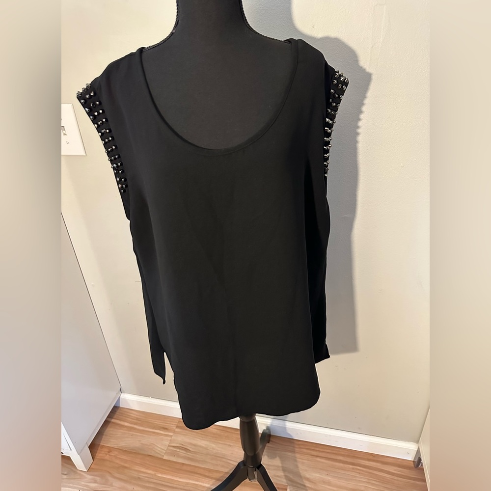 NWOT—-FOREVER 21. Black top with studs on sleeve.